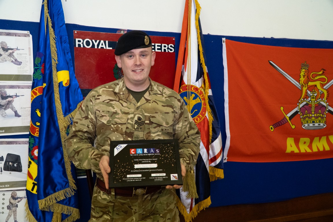 Sergeant Fraser Martin holding his CARAs award