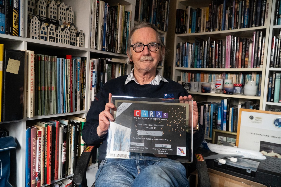 Civilian Instructor John Davies holding his CARAs award