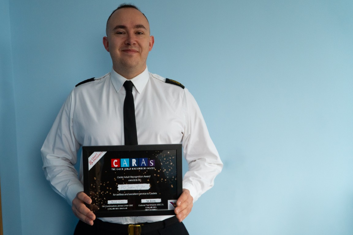 Petty Officer Justin McGhee holding his CARAs award