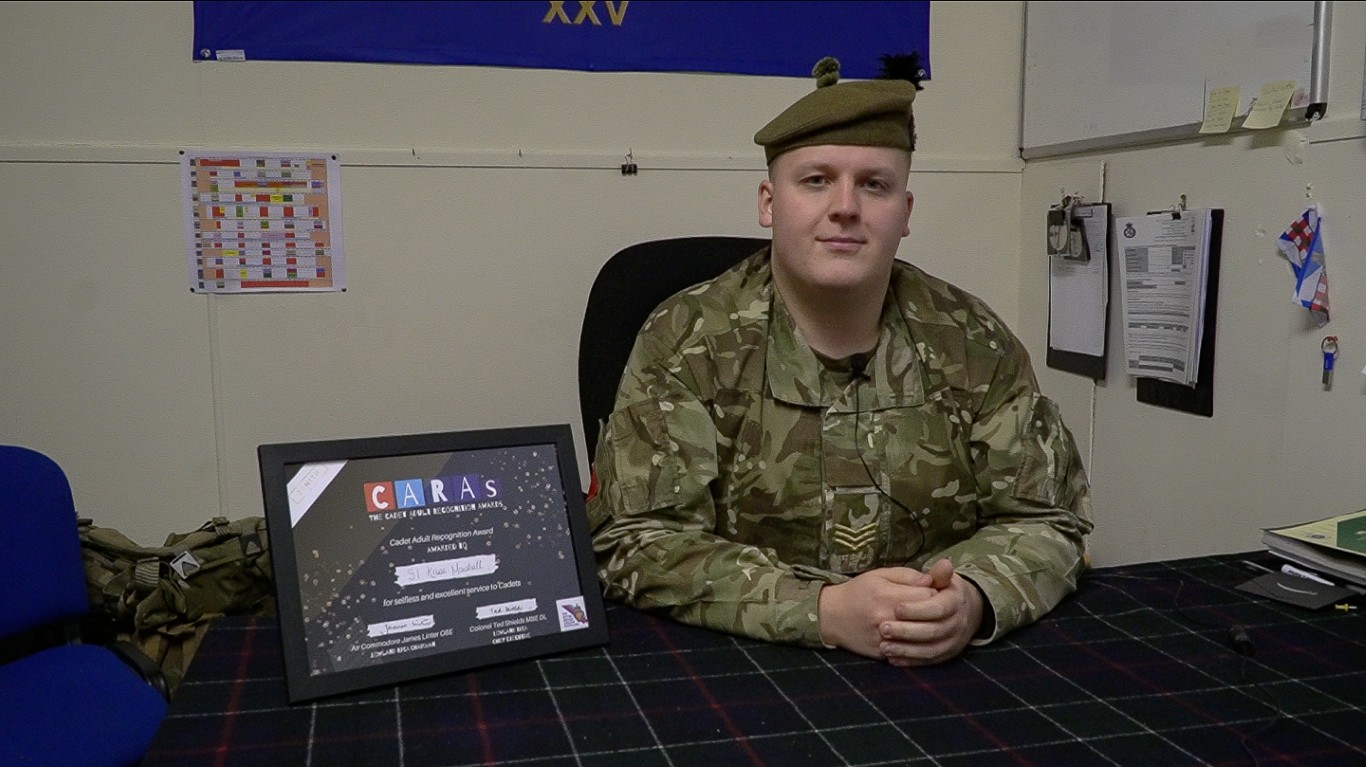 Sergeant Kane Marshall holding his CARAs award