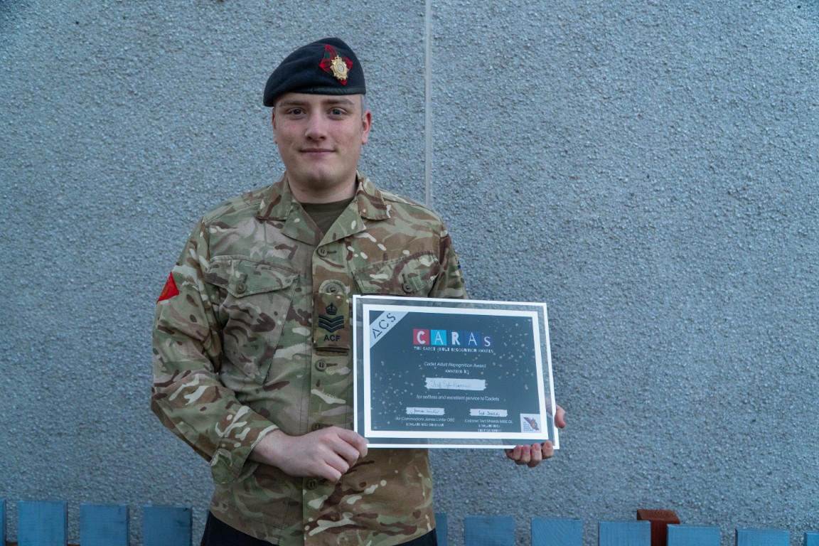 Staff Sergeant Hirvonen holding his CARAs award