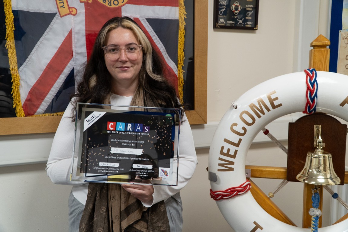 Petty Officer Victoria Lonie holding her CARAs award